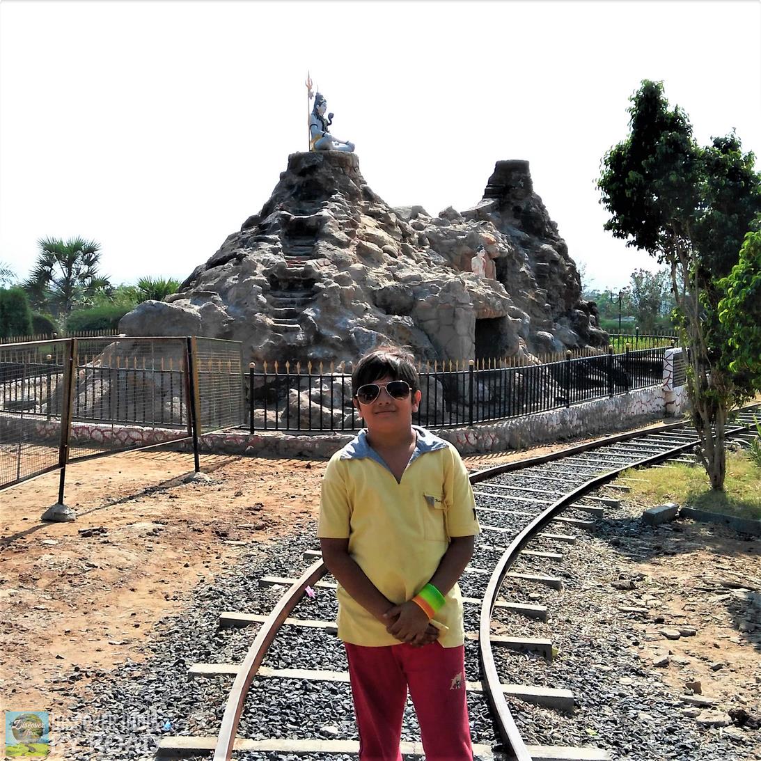 Toy Train track with Shiva statue in background at hill garden bhuj